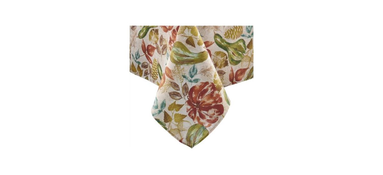 A white tablecloth with multicolored leaf and gourd motifs