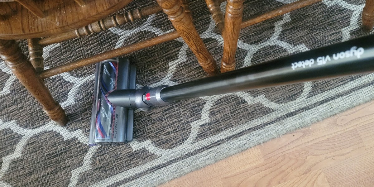 Dyson V15 Detect vacuuming under chair on area rug Dyson V15 Detect vacuuming under chair on area rug