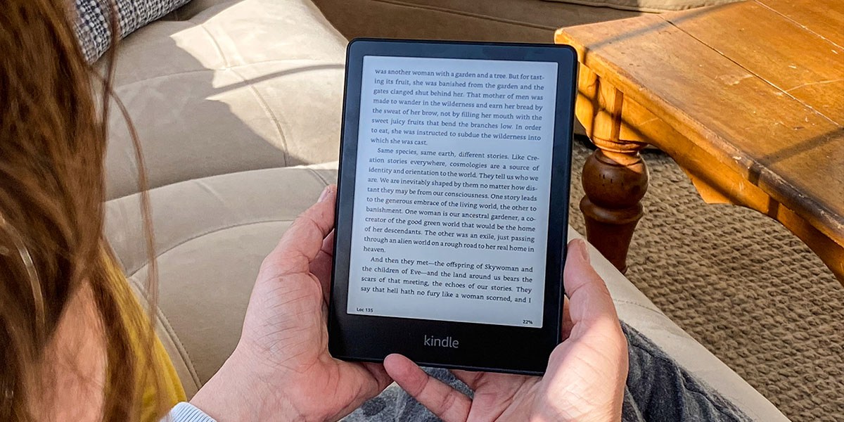 Two hands holding Kindle Paperwhite