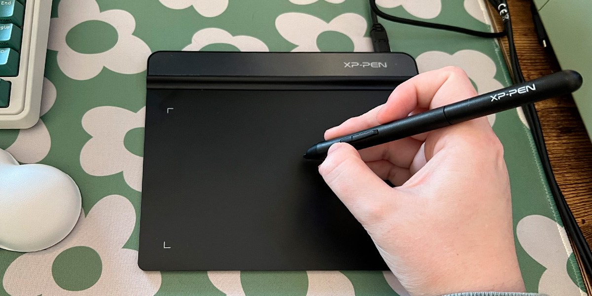 Hand using drawing pen on XP-Pen Star G640 Drawing Tablet