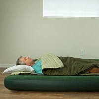 a man sleeping on an air mattress