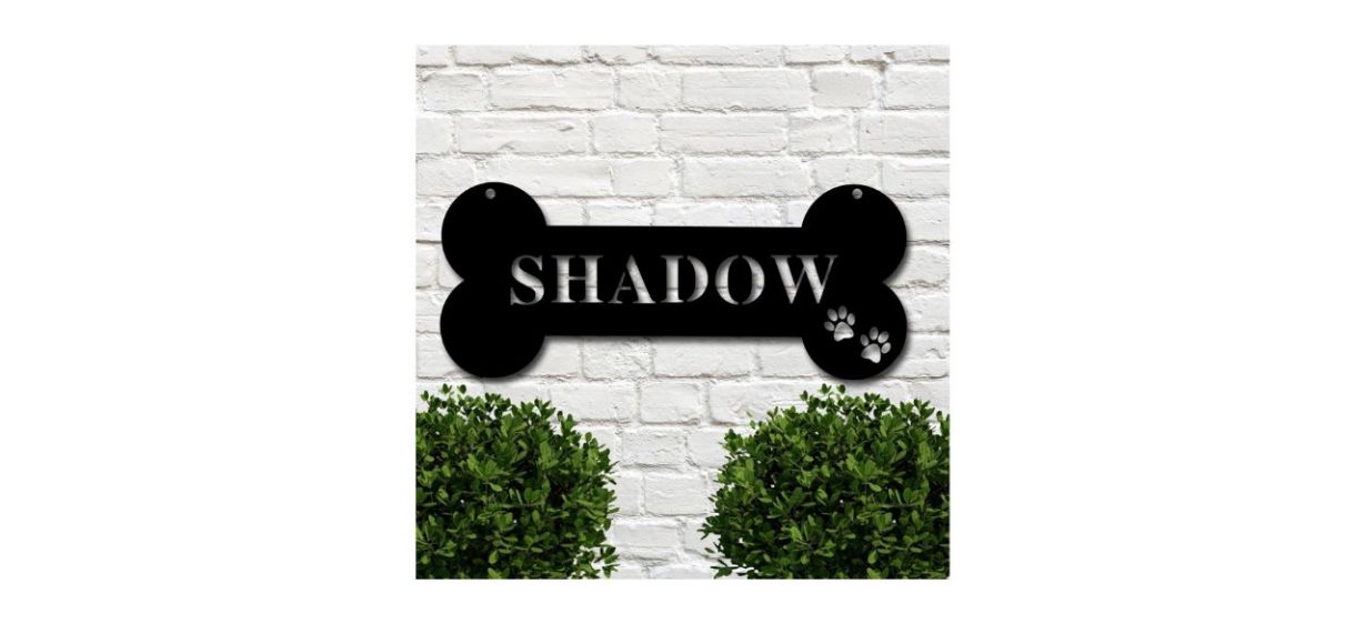 black, bone-shaped name plate attached to a house