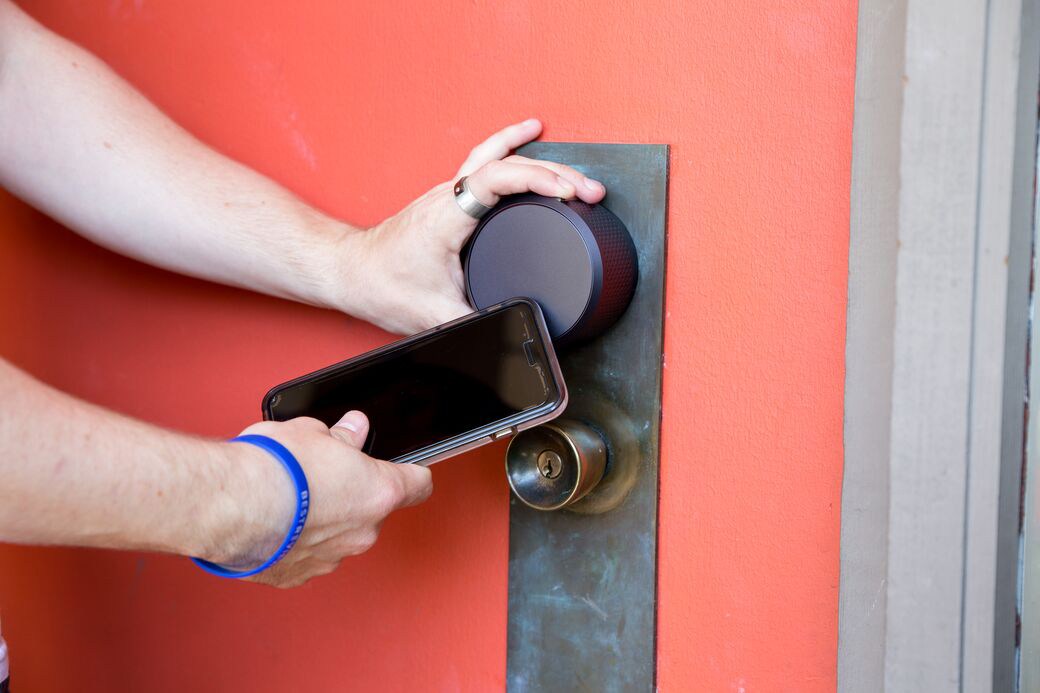 Person unlocking door with smartphone app