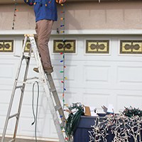 a man removing Christmas lights